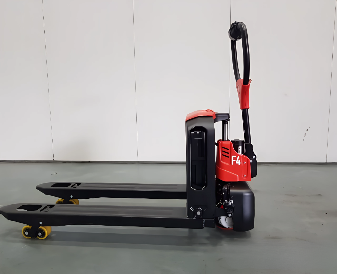 Side view of a red and black electric pallet jack with yellow wheels, set against a white wall in a warehouse-like environment.