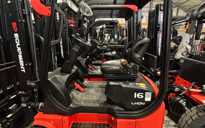Row of red and black EP forklifts displayed in a warehouse, showcasing their ergonomic design and storage capabilities.