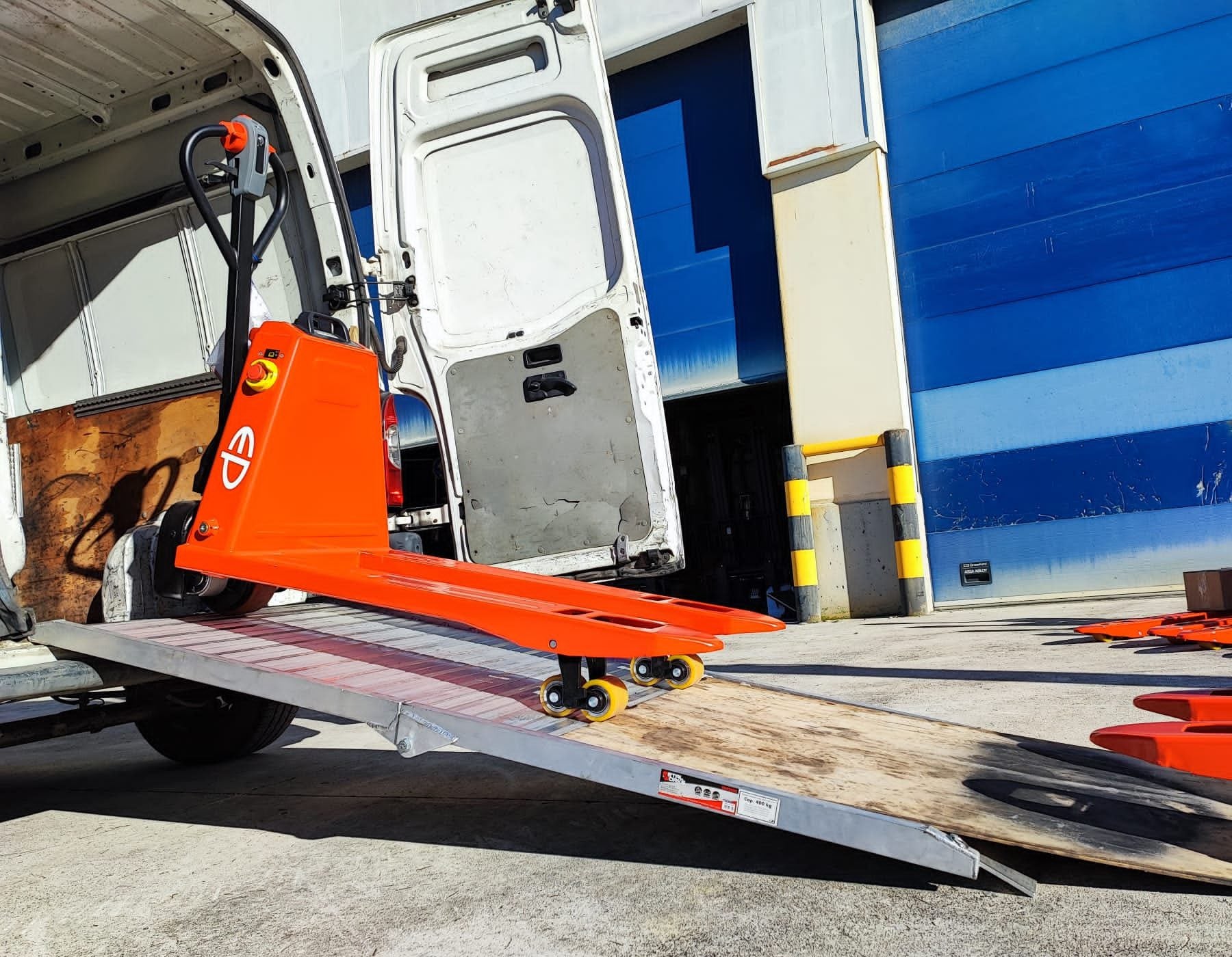 Side view of a red EP electric pallet truck labeled 'EPL1531 Li-ion,' featuring extended forks and a streamlined design, displayed on a white background