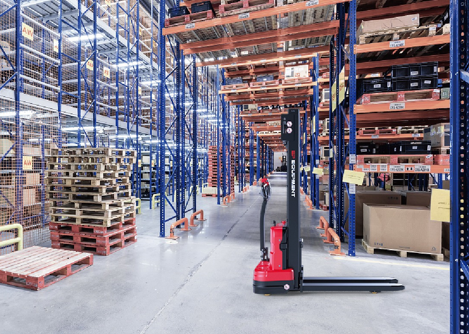 Front angled view of a red and black EP ESl122 electric stacker truck, featuring tall lifting masts and a compact handle design, positioned on a white background