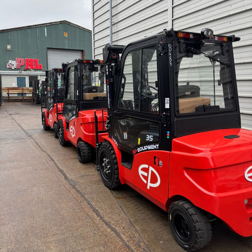 Red forklifts parked in front of a building with 'EP' branding.