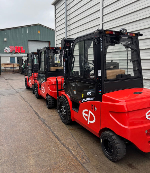Red forklifts parked in front of a building with 'EP' branding.
