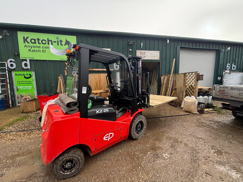 Red forklift in front of a building with 'Katch-it' branding.