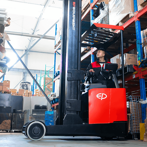 Warehouse worker operating a red electric reach truck by EP Equipment, lifting goods high onto shelves in a brightly lit warehouse filled with boxes and metal containers.