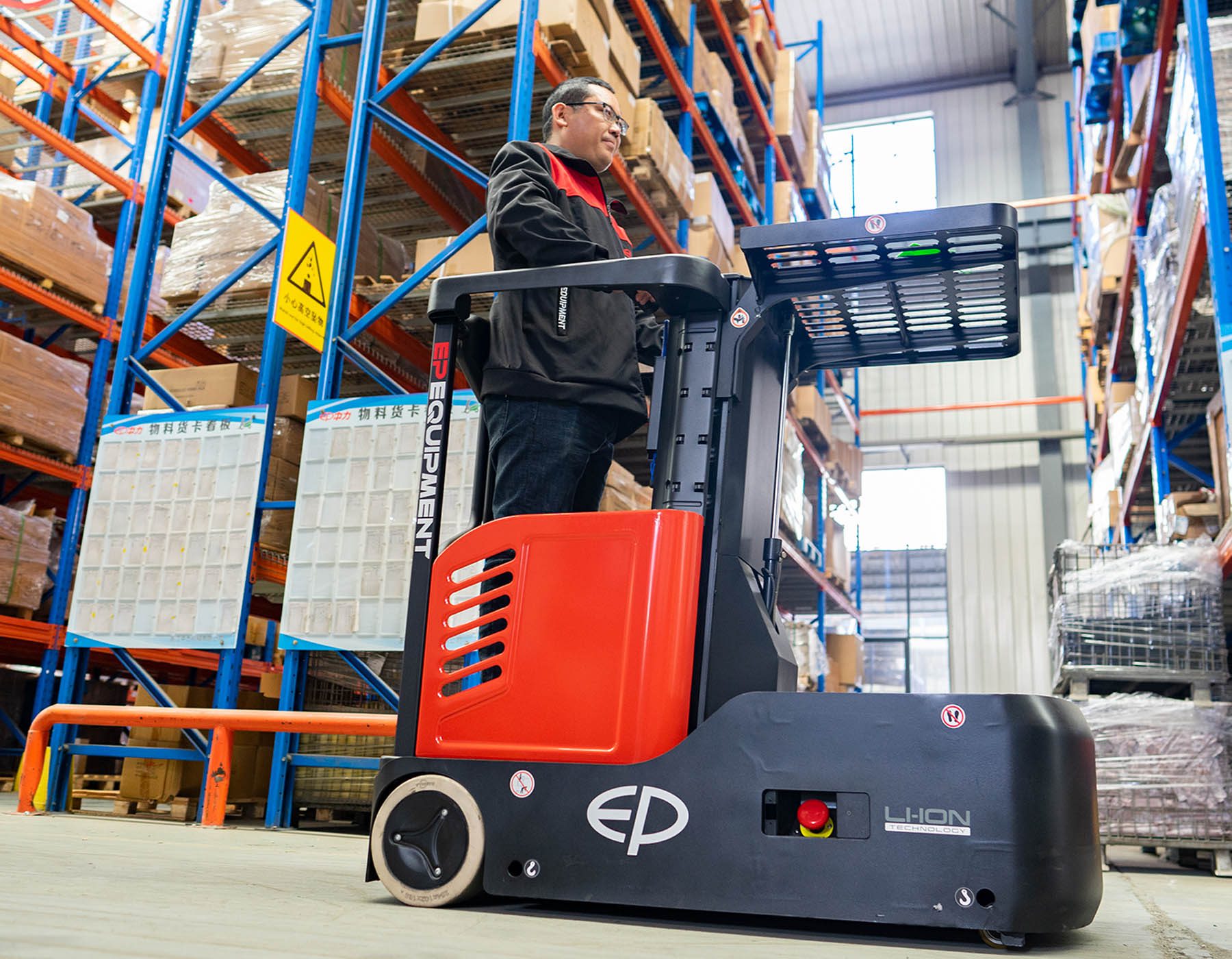 Front angled view of a red and black EP ESl122 electric stacker truck, featuring tall lifting masts and a compact handle design, positioned on a white background